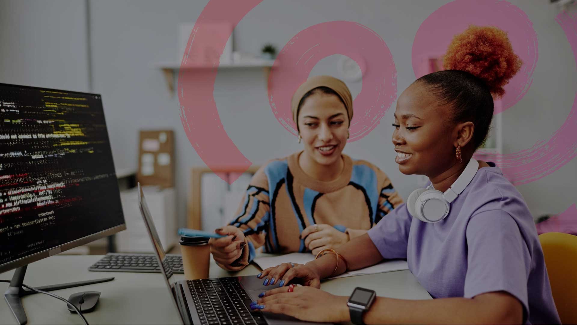 Two women co-workers going over Fuel50 Development insights.